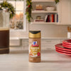 A bottle of McCormick Paprika spice sits on a kitchen counter.