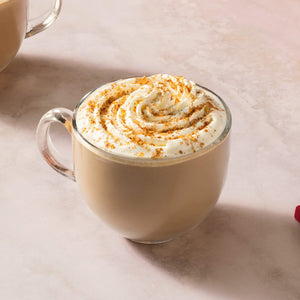 Two mugs of pumpkin spice lattes with McCormick Pumpkin Spice seasoning and pumpkin puree are displayed, suggesting a cozy autumn beverage.