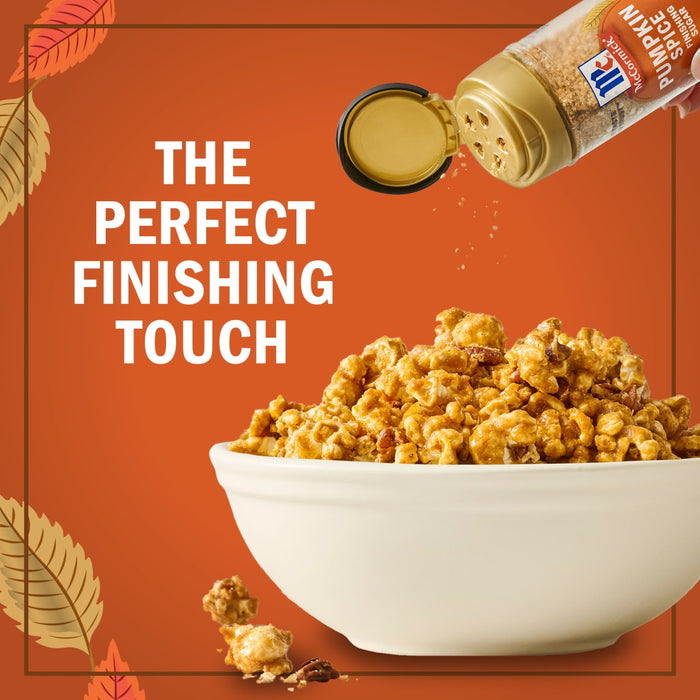 A sprinkle of Kernel Season's Caramel Popcorn Seasoning is being added to a bowl of caramel popcorn, highlighting it as the perfect finishing touch.