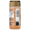 A clear plastic bottle of Mccormick Pumpkin Spice Finishing Sugar Edible Cake Decoration 3.66 Oz showing the nutrition facts and ingredient list including demerara sugar and pumpkin powder.
