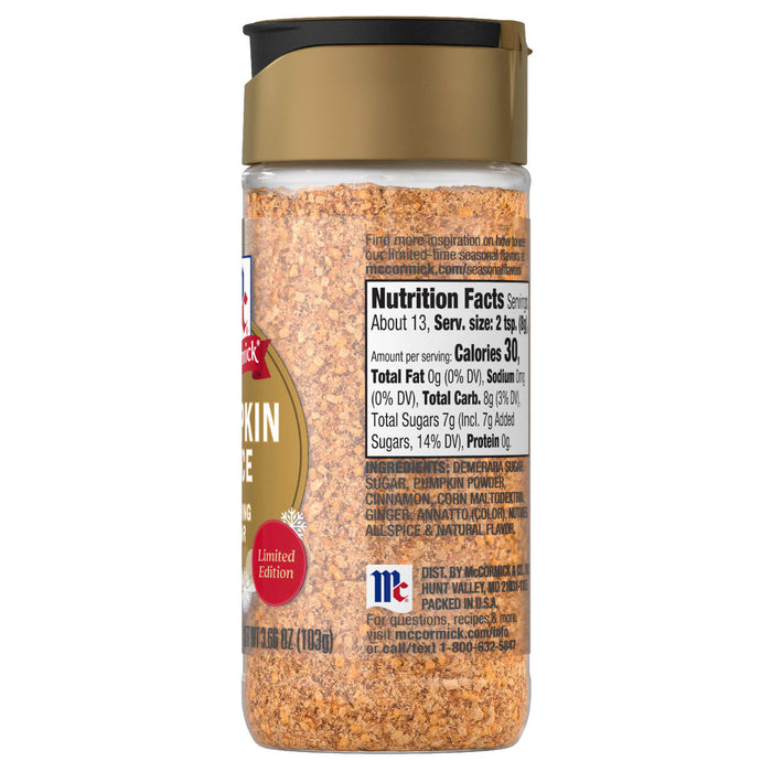 A bottle of Mccormick Pumpkin Spice Finishing Sugar Edible Cake Decoration 3.66 Oz showing the nutrition facts and ingredients like demerara sugar and pumpkin powder.