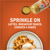 A bottle of McCormick Pumpkin Pie Spice is shown sprinkling spice on waffles, highlighting its versatility for lattes, breakfast bakes, cookies, and cakes.