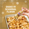A hand shakes McCormick Pumpkin Pie Spice onto a baked dessert to add seasonal flavor.