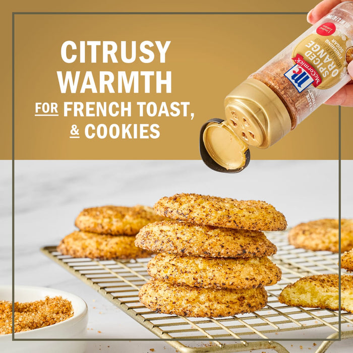 McCormick Citrusy Warmth seasoning is sprinkled on a stack of cookies on a wire rack, suggesting its use on French toast and cookies.