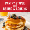 A stack of pancakes with blueberries and syrup is shown highlighting its versatility as a pantry staple for baking and cooking.