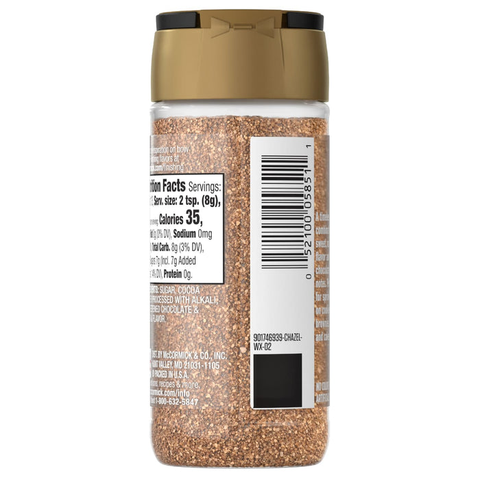 A clear plastic shaker bottle of Mccormick Chocolate Hazelnut Finishing Sugar Edible Cake Decoration 3.61 Oz, showing its brown granular contents and nutrition facts label.