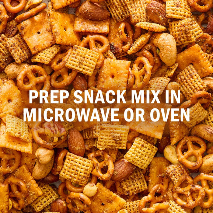 A close-up shot of a snack mix featuring Chex cereal, pretzels, and nuts, with text overlay stating Prep snack mix in microwave or oven.