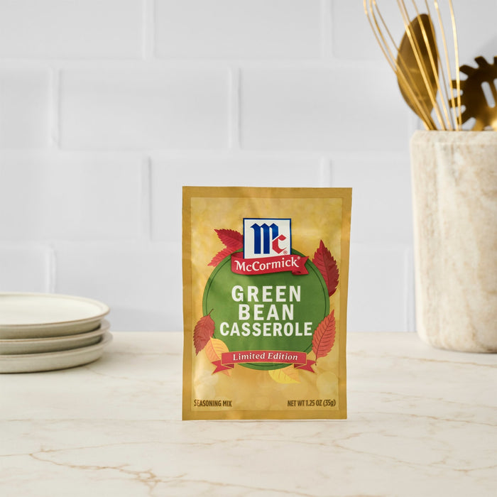 A packet of McCormick Green Bean Casserole seasoning mix sits on a countertop.