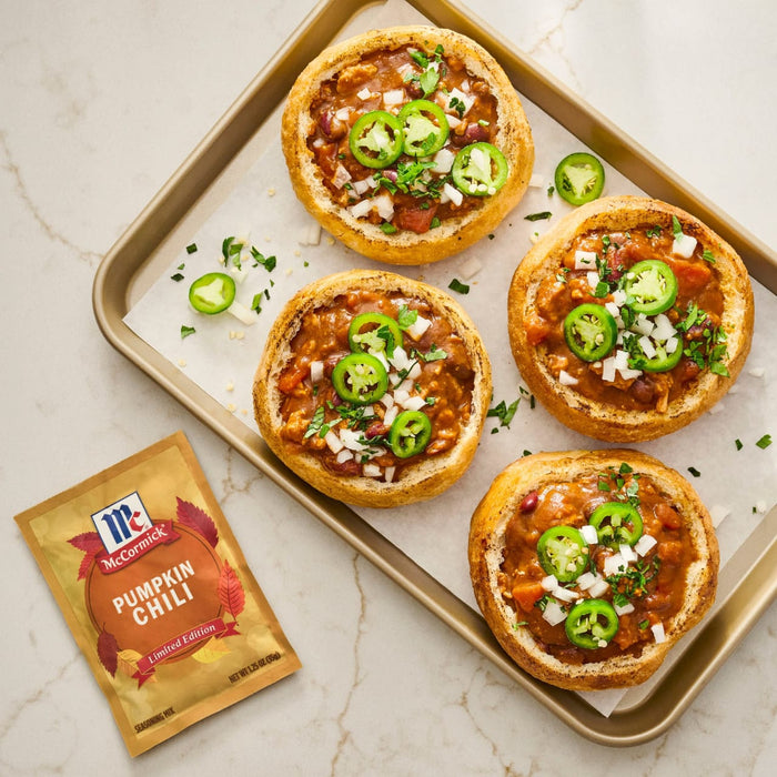 A tray of chili puff pastry tarts topped with jalapeA?os and a packet of McCormick Chili seasoning.