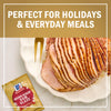 A sliced ham with a McCormick Brown Sugar Ham Glaze packet, perfect for holidays and everyday meals.