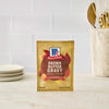 A packet of McCormick Brown Butter Gravy mix is displayed on a countertop.