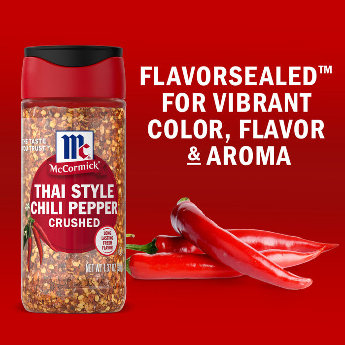 A jar of McCormick Thai Style Chili Pepper Crushed is displayed next to fresh red chili peppers highlighting the products flavor-sealed quality for vibrant color flavor and aroma.