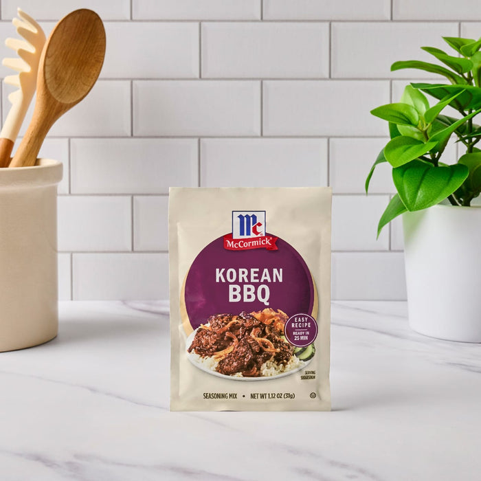 A packet of McCormick Korean BBQ seasoning mix is displayed on a kitchen counter.