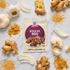 A packet of McCormick Korean BBQ seasoning mix is surrounded by ginger garlic onion brown sugar and sesame seeds.