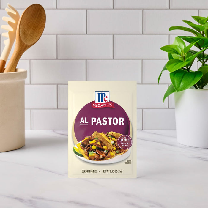 A packet of McCormick Al Pastor seasoning mix is displayed on a kitchen counter.