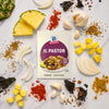 A packet of McCormick Al Pastor seasoning mix is surrounded by ingredients like pineapple onion garlic and spices.