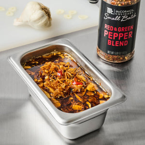 A metal container filled with a red and green pepper blend from McCormick Culinary Small Batch.