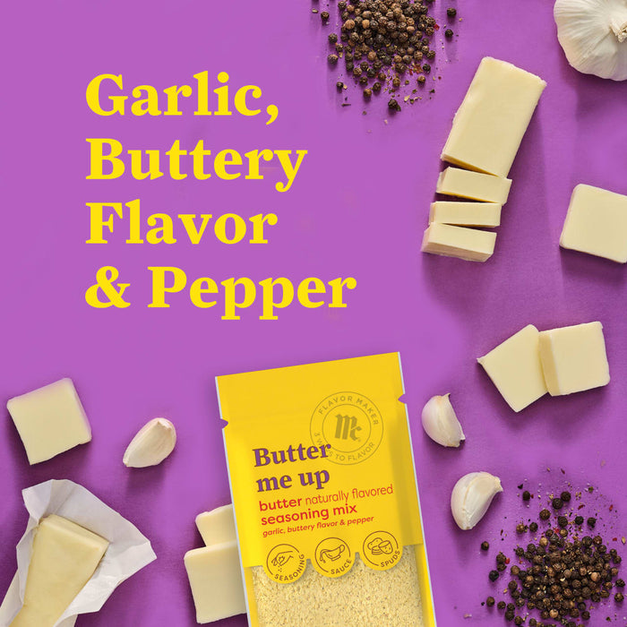 This is a product shot of McCormick Butter Me Up seasoning mix surrounded by butter garlic and peppercorns.