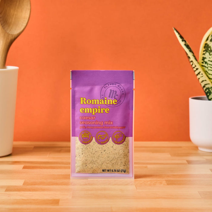 A packet of Romaine Empire caesar seasoning mix is displayed highlighting its use for dressing sauce and seasoning.