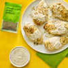 This image features Tyson Green Goddess Chicken with a packet of seasoning and a bowl of dipping sauce showcasing a flavorful meal option.