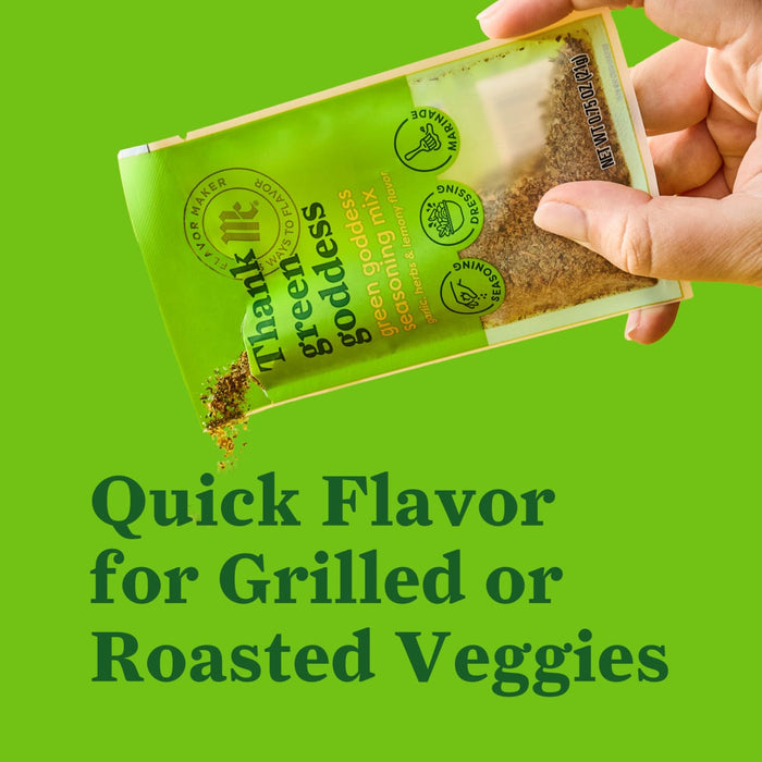 A hand pours the contents of a Thank Green Goddess seasoning packet highlighting its use for adding quick flavor to grilled or roasted vegetables.