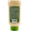 A bottle of a creamy sauce with a green label and cap shows the product's ingredients and nutritional information.