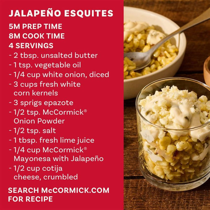 A glass serving of Jalapeño Esquites featuring Mexican street corn in salad form with creamy heat sits on a rustic wooden table alongside lime wedges and a prompt to search McCormick.com for the recipe.