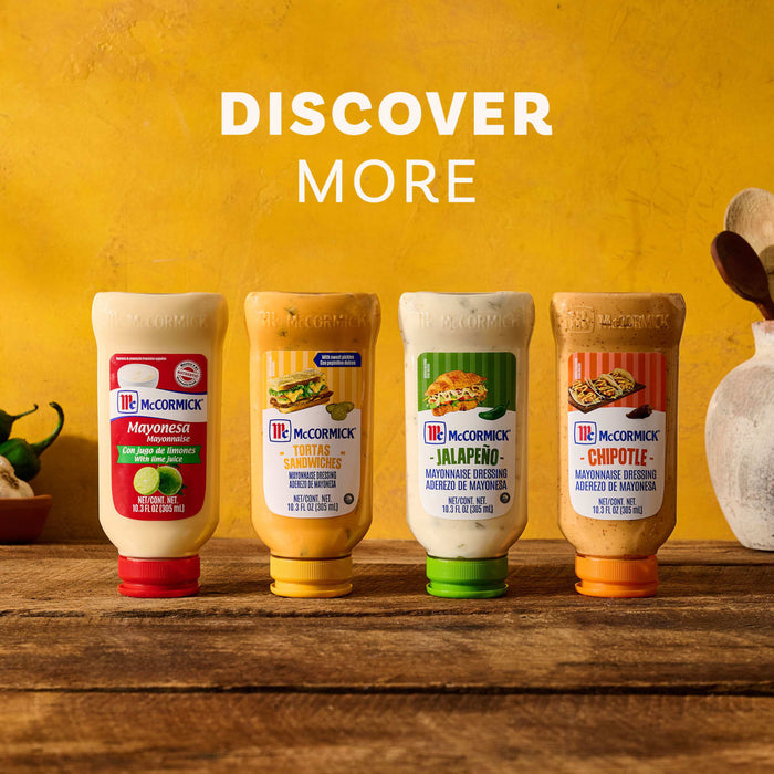 A lineup of four McCormick squeeze bottles featuring Mayonesa with lime juice, Tortas Sandwiches, Jalapeño, and Chipotle mayonnaise dressings on a rustic wooden table against a yellow background with the text DISCOVER MORE.