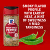 A jar of McCormick Hatch Chile Pepper Crushed seasoning is displayed next to fresh green hatch chiles highlighting its smoky flavor profile with earthy heat a hint of sweetness and mild tanginess.