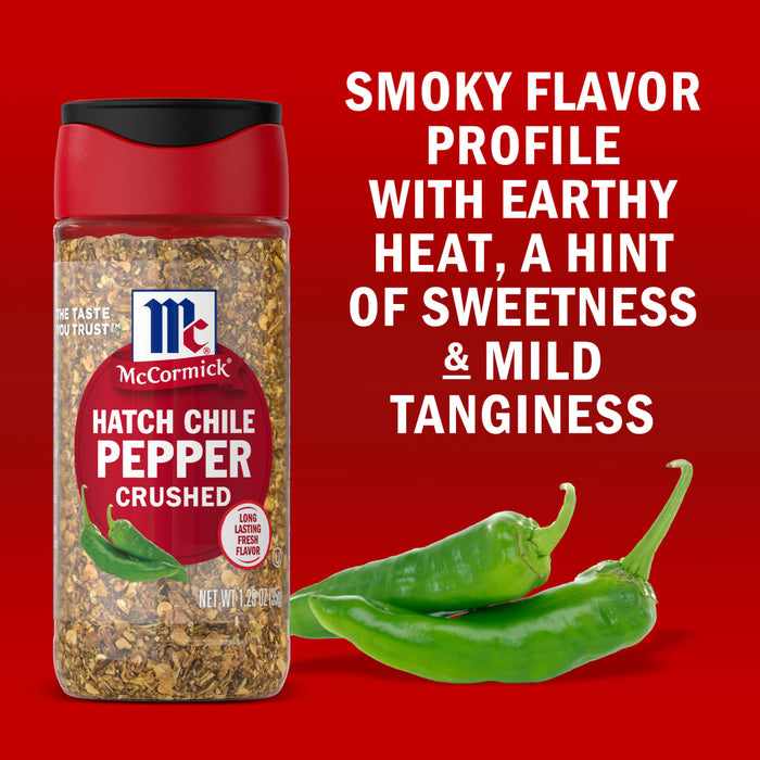 A jar of McCormick Hatch Chile Pepper Crushed seasoning is displayed next to fresh green hatch chiles highlighting its smoky flavor profile with earthy heat a hint of sweetness and mild tanginess.