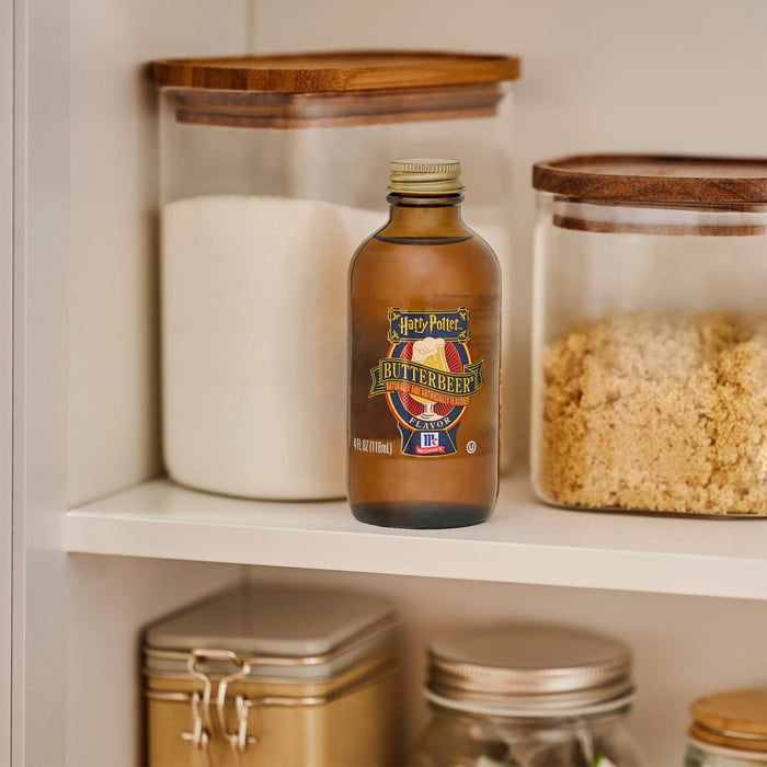 A bottle of McCormick Harry Potter Butterbeer Naturally and Artificially Flavored Flavor sits on a shelf among jars of sugar.