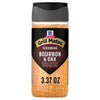 A clear plastic bottle of Mccormick Grill Mates Gm Bourbon &amp; Oak 3.37 Oz seasoning with a black label and cap, filled with light brown granular spice.