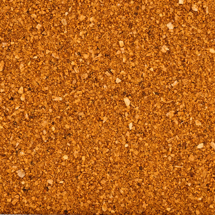 A close-up, top-down view shows the coarse texture of Mccormick Grill Mates Bourbon &amp; Oak Seasoning Ground 3.37 Oz.