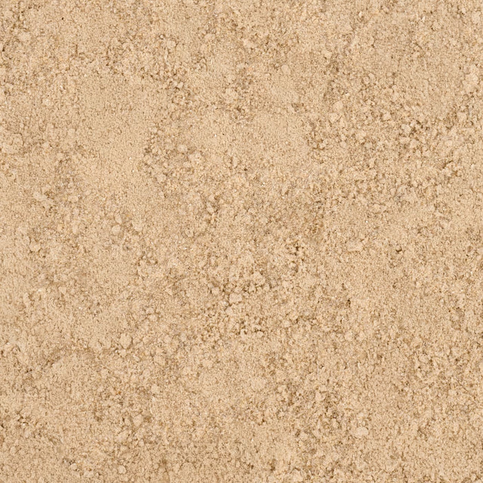 A close-up texture of fine, light brown sand.