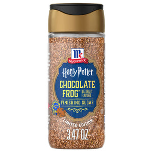 A clear shaker jar of Mccormick Harry Potter Chocolate Frog Finishing Sugar, 3.47 Oz, is shown against a white background, revealing the brown, coarse sugar crystals inside.