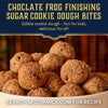 Edible chocolate chip cookie dough bites are piled in a bowl and topped with a generous sprinkle of Mccormick Harry Potter Chocolate Frog Finishing Sugar, 3.47 Oz.