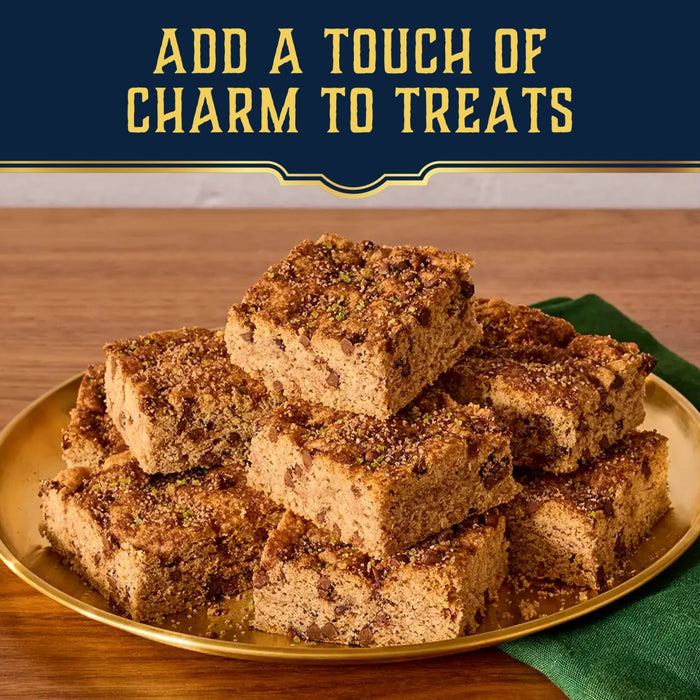 A golden plate piled with cake bars is shown to demonstrate how Mccormick Harry Potter Chocolate Frog Finishing Sugar, 3.47 Oz can add a touch of charm to treats.