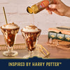 A hand sprinkles Mccormick Harry Potter Cauldron Cake Finishing Sugar, 3.43 Oz over two chocolate sundaes to create a magical, Harry Potter-inspired dessert.