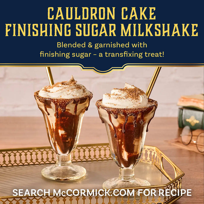 Two decadent Cauldron Cake Finishing Sugar Milkshakes are garnished with Mccormick Harry Potter Cauldron Cake Finishing Sugar, 3.43 Oz, and served on a gold tray.