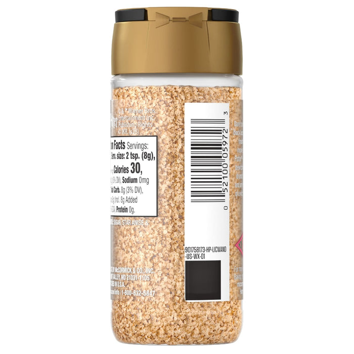 A clear plastic bottle of Mccormick Slytherin Finishing Sugar Harry Potter 3.37 Oz, filled with light brown granular sugar, displays its nutrition facts label and barcode on the side, topped with a gold and black cap.