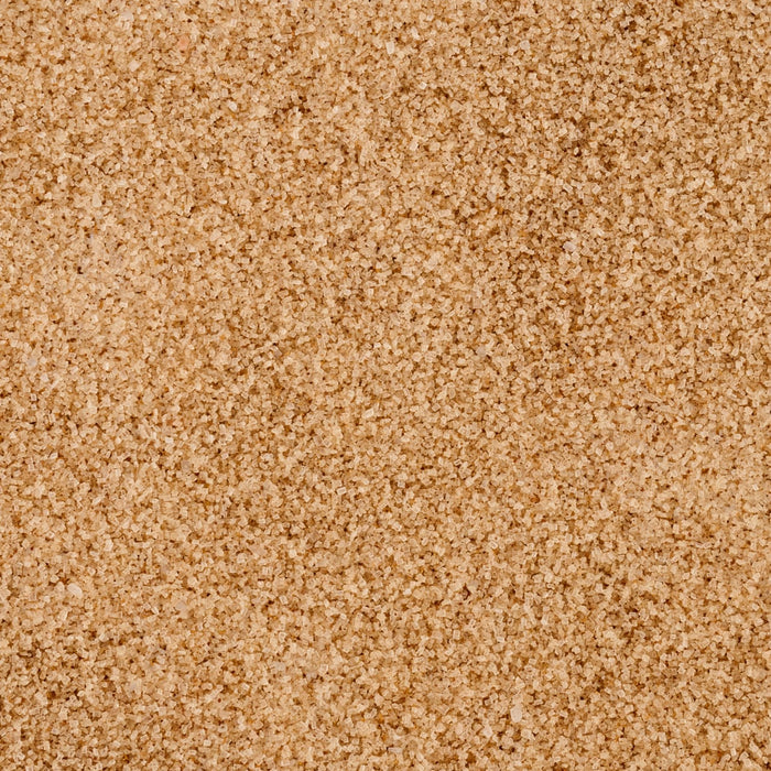 A close-up, top-down view reveals the texture of the Mccormick Harry Potter Licorice Wand Finishing Sugar, 3.39 Oz, showing its light brown, crystalline grains.