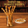 Twisted pastry wands coated with Mccormick Harry Potter Licorice Wand Finishing Sugar, 3.39 Oz are presented in a glass jar and on a plate to show they are perfect for dramatic desserts.