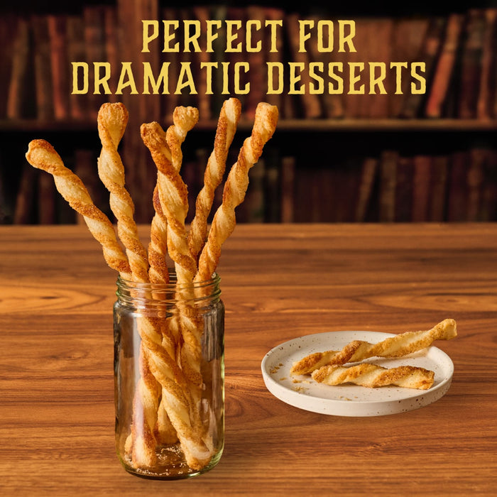 Twisted pastry wands coated with Mccormick Harry Potter Licorice Wand Finishing Sugar, 3.39 Oz are presented in a glass jar and on a plate to show they are perfect for dramatic desserts.