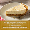 A slice of silky salted caramel cheesecake with a thick graham cracker crust is presented on a white plate as a serving suggestion for Mccormick Salted Caramel Cheesecake Seasoning Mix, 1.62 Oz.