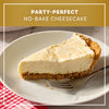 A slice of party-perfect no-bake cheesecake prepared with Mccormick Salted Caramel Cheesecake Seasoning Mix 1.62 Oz sits on a white plate with a fork.