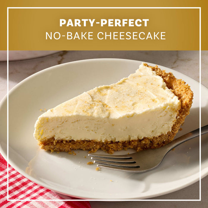 A slice of party-perfect no-bake cheesecake prepared with Mccormick Salted Caramel Cheesecake Seasoning Mix 1.62 Oz sits on a white plate with a fork.
