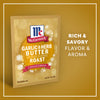A single packet of Mccormick Garlic And Herb Butter Roast Seasoning Mix, 1.0 Oz is displayed against a golden background with festive snowflake accents and text highlighting its rich and savory flavor and aroma.