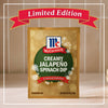 A festive gold and green packet of Mccormick Creamy Jalapeno Spinach Dip Seasoning Mix, 0.87 Oz is displayed as a limited edition holiday product against a tiled background.