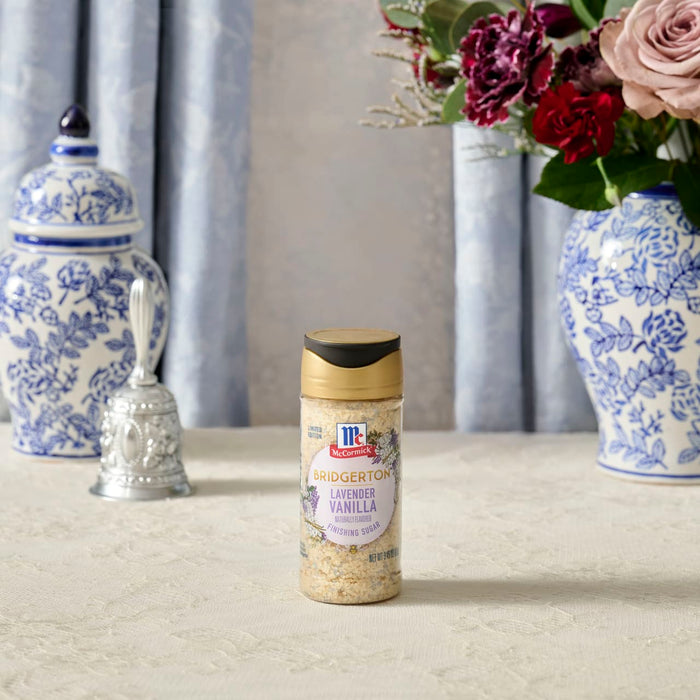 A bottle of McCormick Creamy Garlic Parmesan Ranch Dressing stands on a table with decorative vases and flowers.