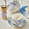 A cup of tea with McCormick Cinnamon Sweet Salt next to a teapot, suggesting a cozy and flavorful tea experience.